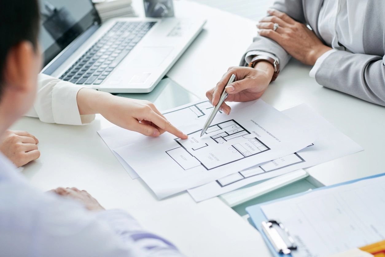 people at a desk planning the house design