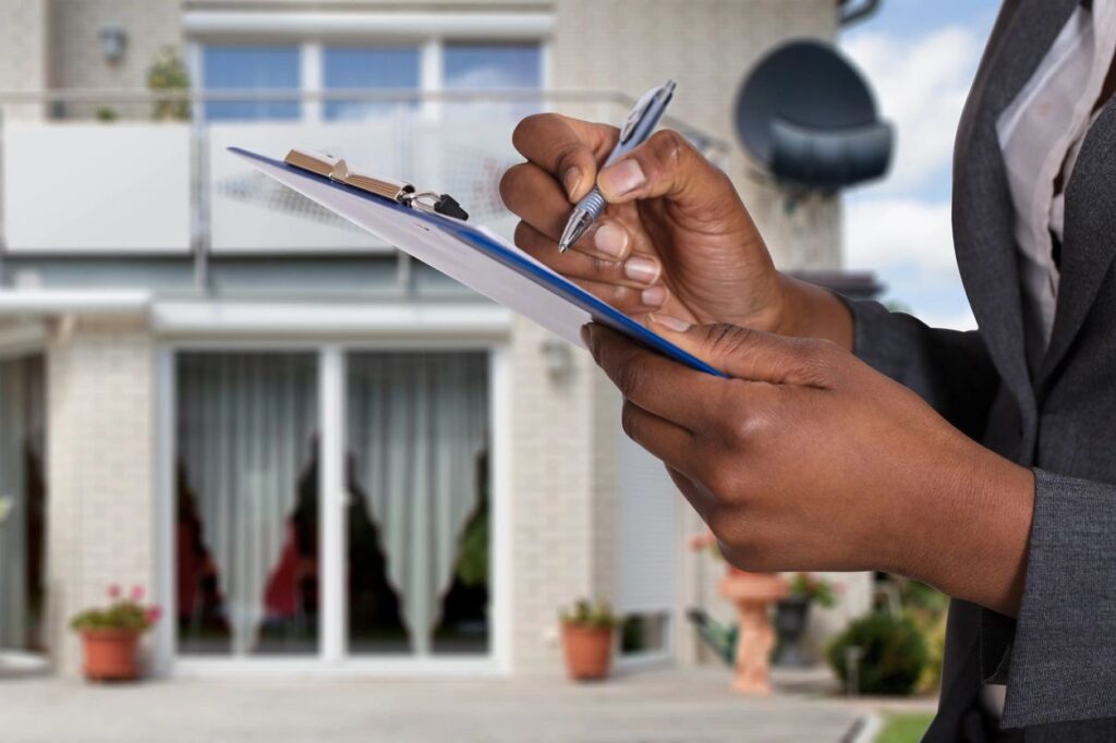 realtor writing on a clipboard